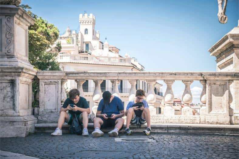 3 teenage boys in Rome taking a break from warm weather sightseeing