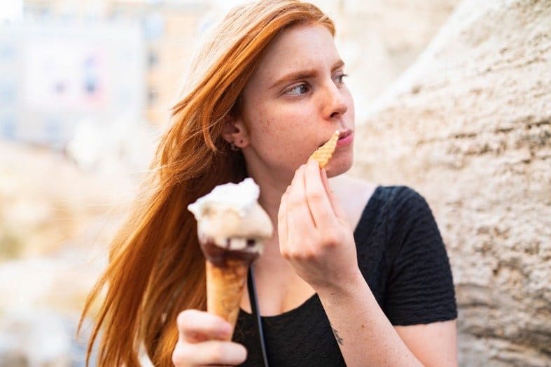 A teenage girl in Rome eating Gelato Ice Cream