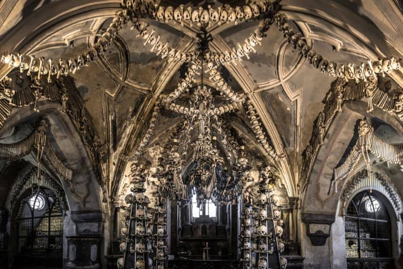 Human skulls and bones on the walls at Kunta Hora chapel. They look like they make a macabre garland hanging from the roof and making a sort of altar at the back of the church
