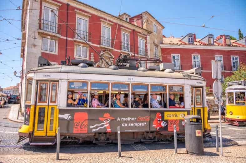 a lisbon historic yellow tram travelling through the city
