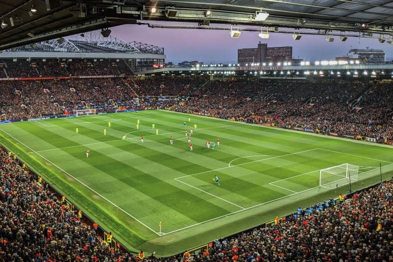 Manchester United stadium at Old Trafford full of people watching a Premier League game.