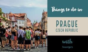 Teenagers on a tour listening to a guide in Prague