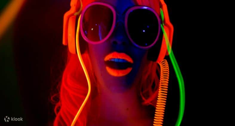 A teenage girl illuminated with neon at Queenstown putt and glow