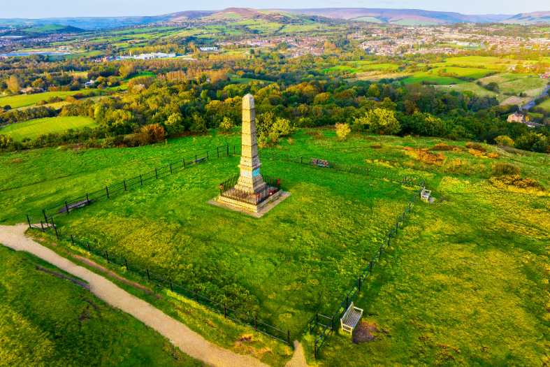 A hill near manchester with a marker ontop