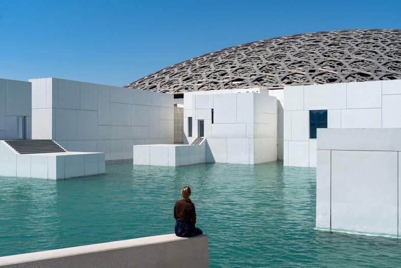 a teenage girl looking at the Abu Dhabi arcitecture