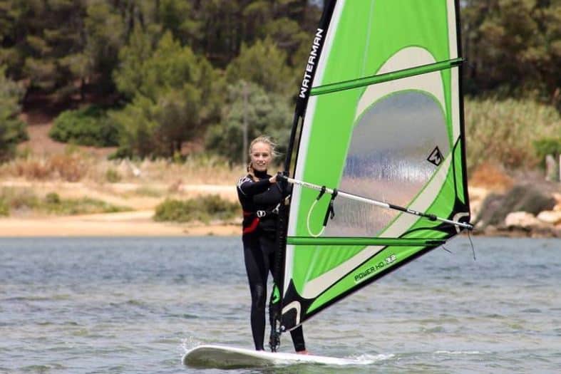 A teenage girl learning to windsurf on the Algarve