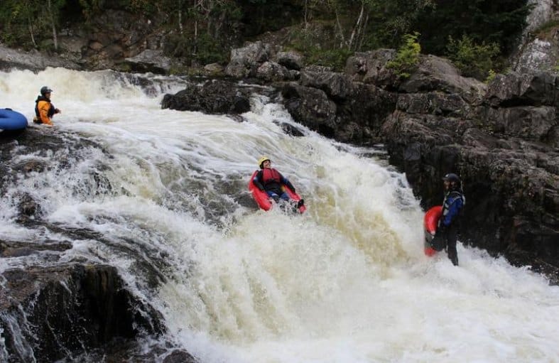 a young adult doing river bugging near Edinburgh in Scotland