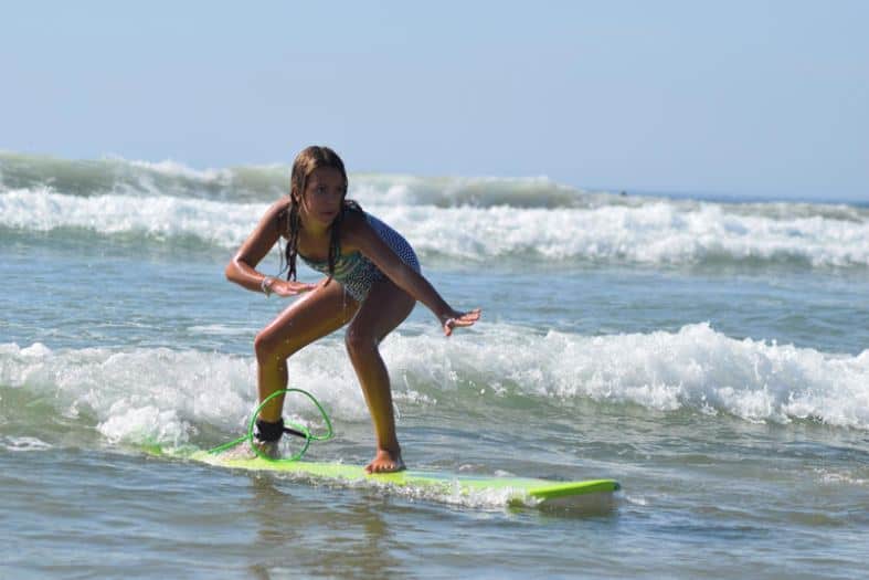 a teenage girl learning to surf in Portugal