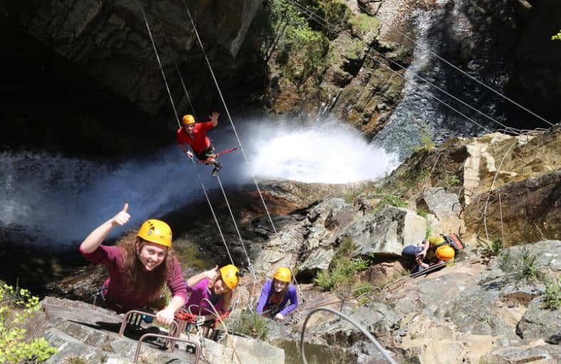teens climbing the wall at Via ferrata in Scotland