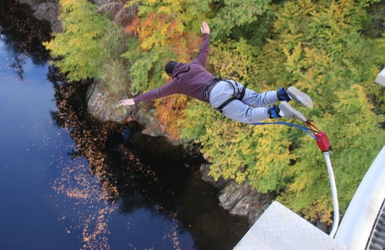 a young adult teenager Bungee jumping in Scotland