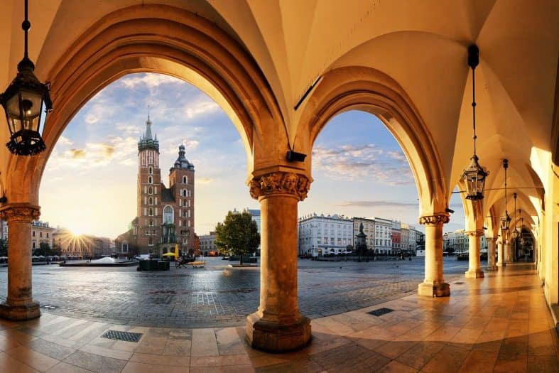 A sunrise picture of the Market Square in Krakow old town from under the arches of the Market building.