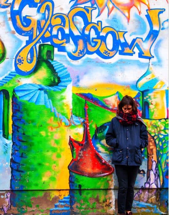 a teenager in Glasgow looking at street art