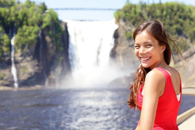 a young girl looking at the waterfall