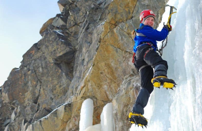 a teen girl climbing an ice wall