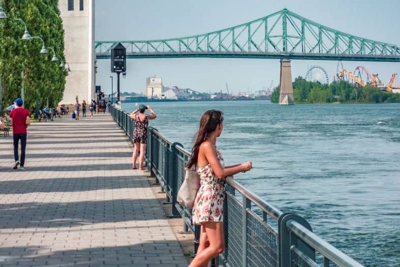 People enjoying the picturesque scene with the tranquil river flowing from the river in Montreal
