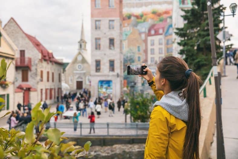 a teenage girl in Montreal taking pictures of street art