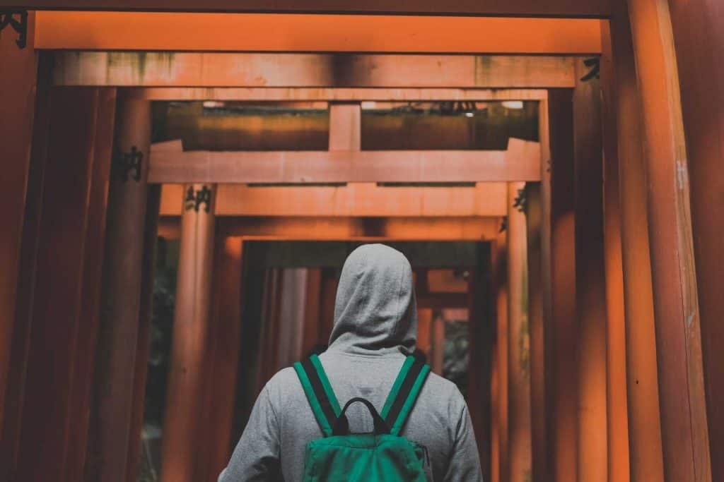 a teenage boy exploring the Fushimi Inari Shrine in Kyoto