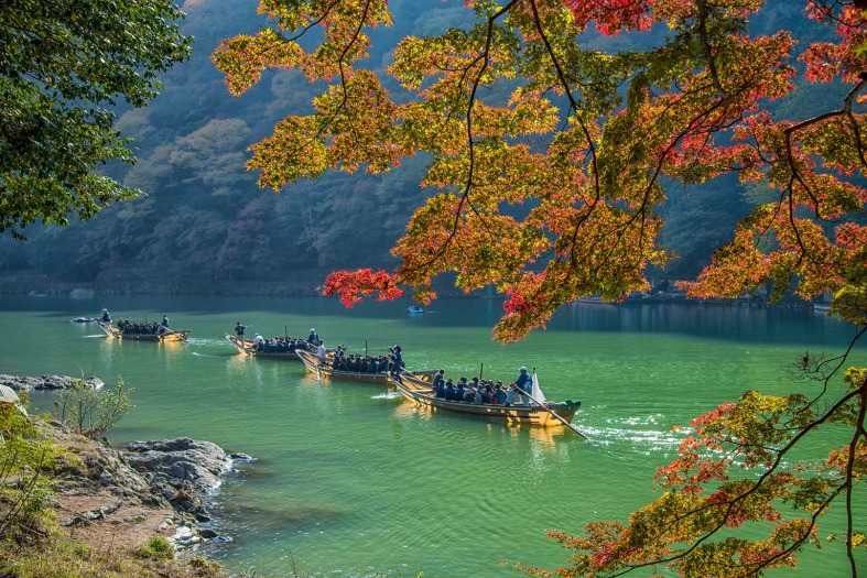 4 boats going down the Hozugawa River near Kyoto