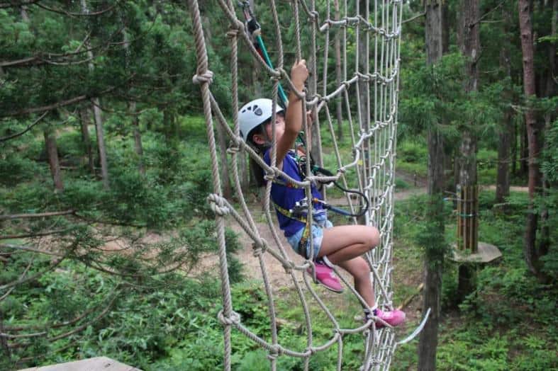 a kid in Osaka climbing a rope net