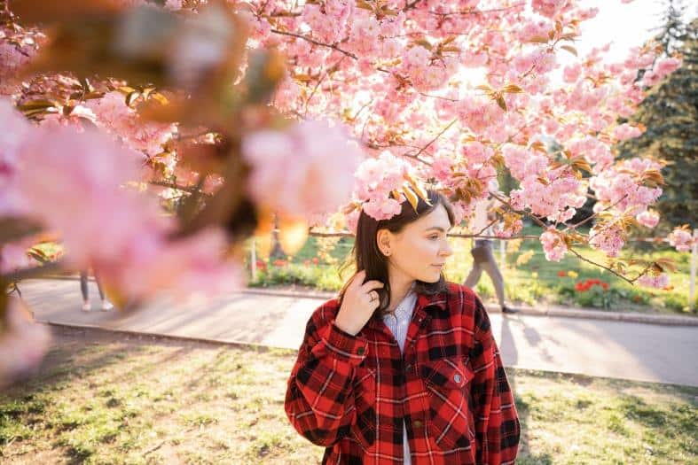A teenage girl visiting Osaka to see the Cherry Blossoms.