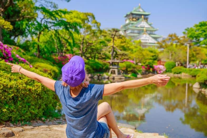 a teen sitting by the water in kyoto