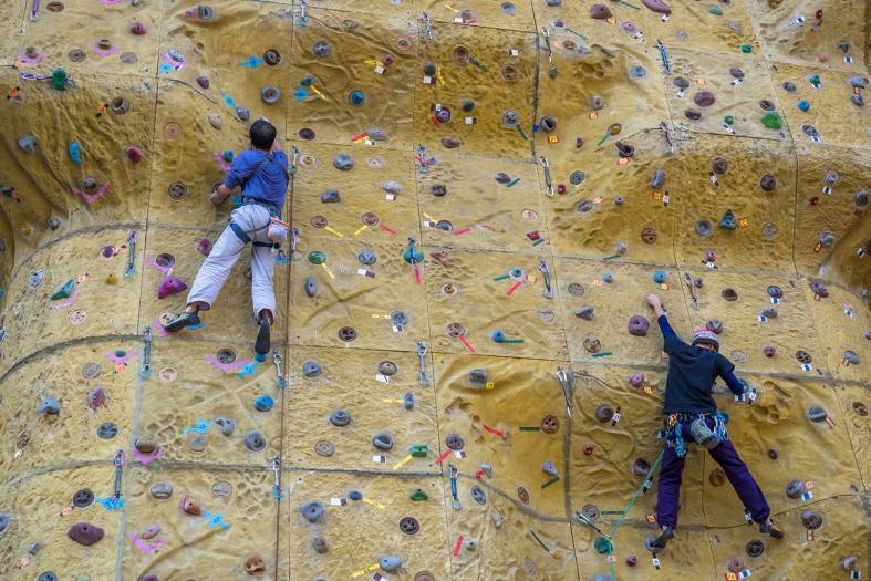 Two teens climbing the wall. at an indoor rock climbing center in Osaka
