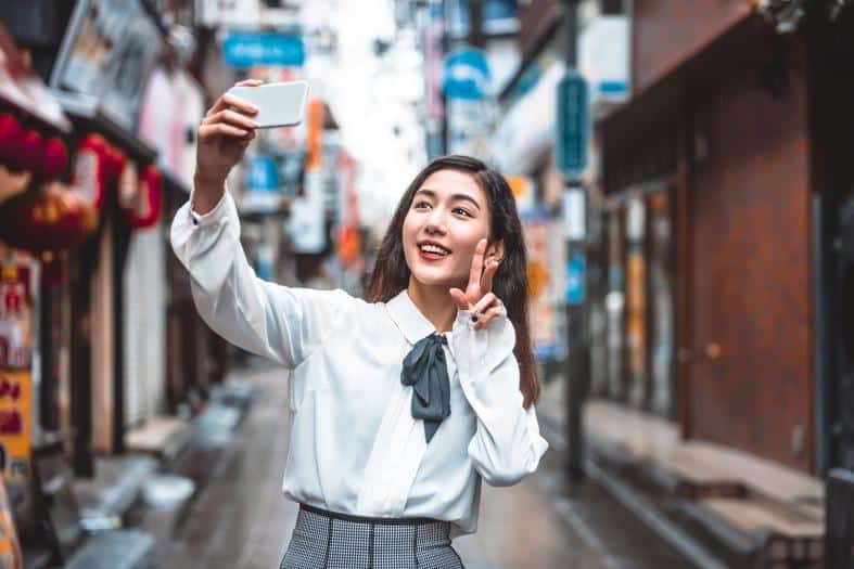 A teenage girl in tokyo taking a selfie
