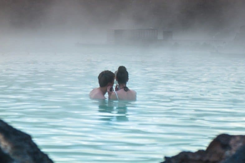 A couple relaxing after getting to the blue lagoon from Reykjavík
