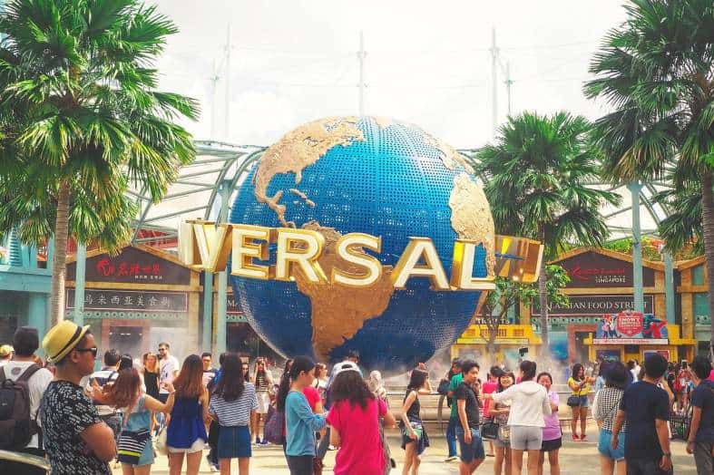 Tourists taking pictures in front of Universal Studios in Los Angeles