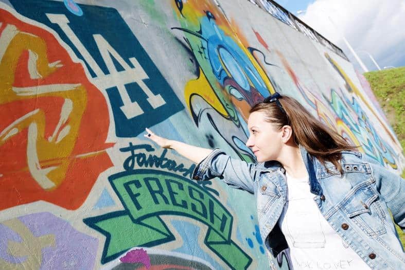 a teenagers looking at street art in Los Angeles