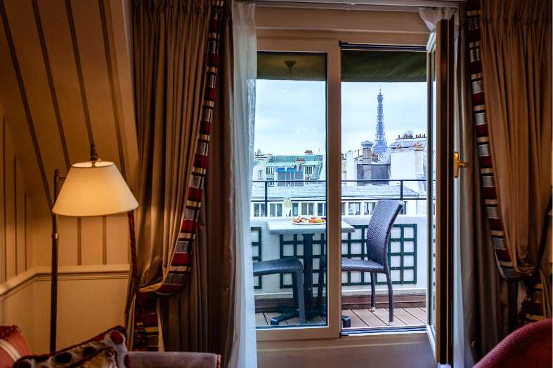 Looking out the window of a hotel at the Eiffel Tower in Paris