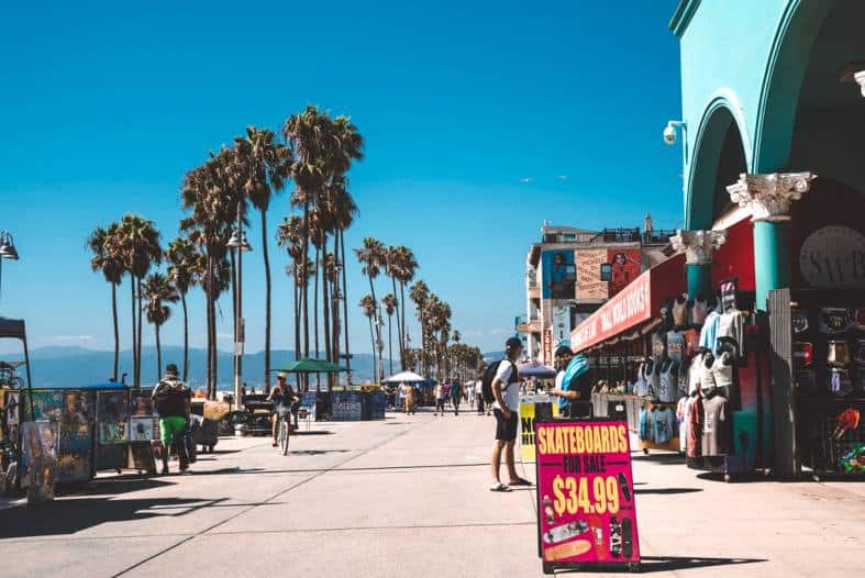 Venice beach shops and palm tress on a sunny day