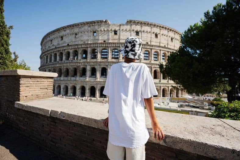 a teenager looking at the Colosseum in Rome, Italy
