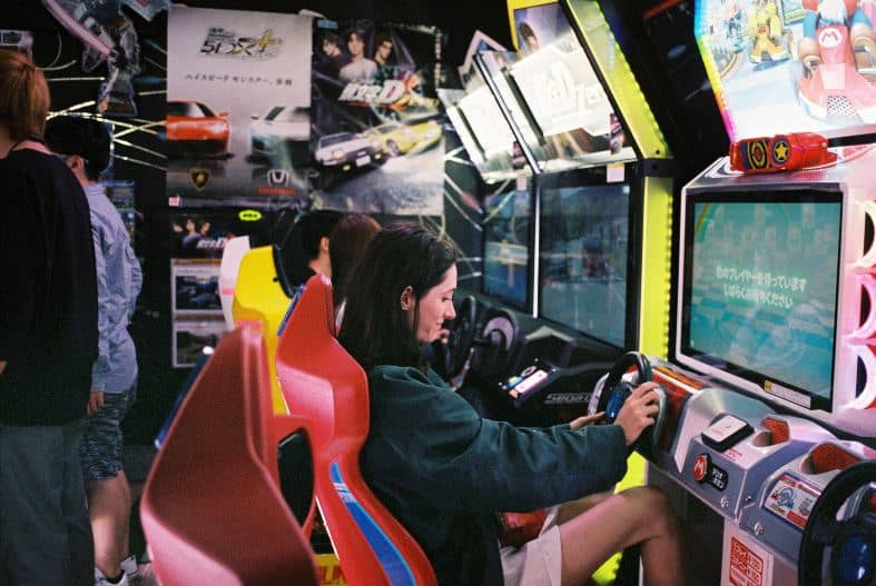 a teenage girl playing games at a amusement arcade