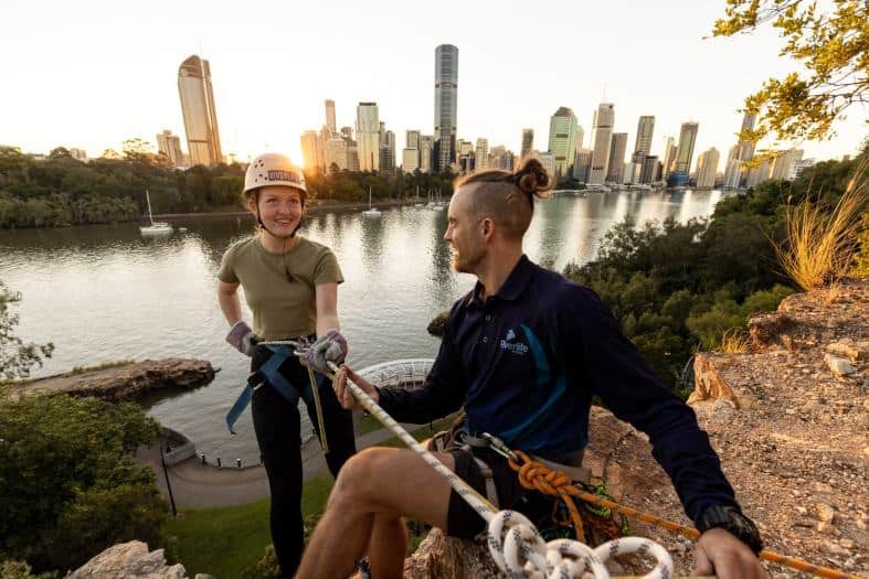 A young lady about to abseil down a cliff in Brisbane