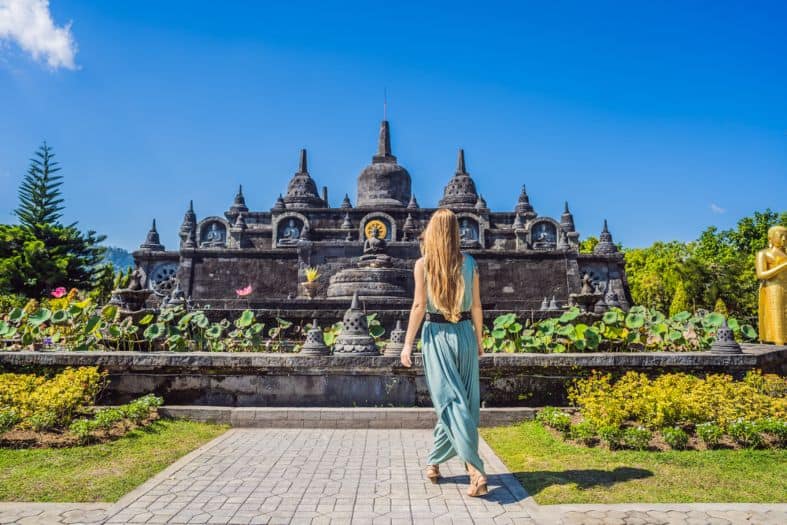 A girl in the peaceful ambiance in the sacred place at Brahma Vihara Arama