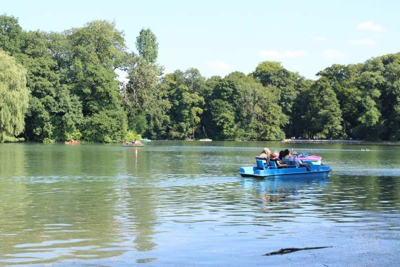 a family enjoying a paddle boat in the Munich English Garden