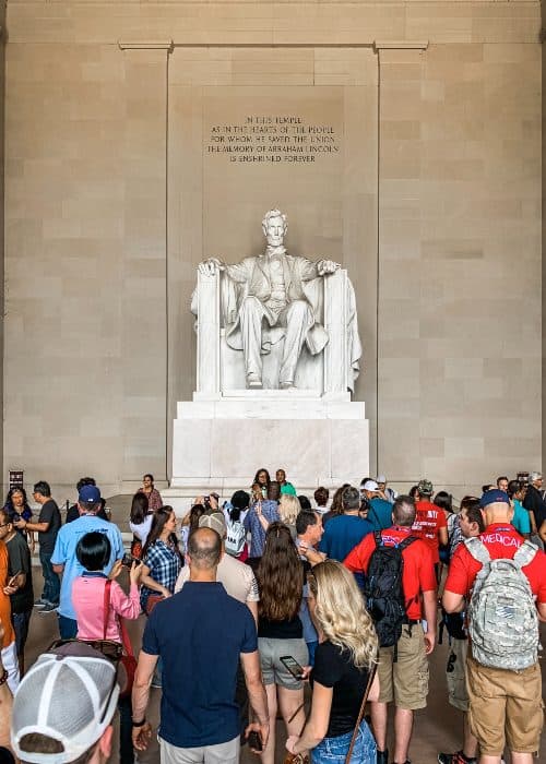 crowds of tourist flockinh around the Abraham Lincoln Memorial in Washington D.C