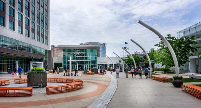 a group of people walking around a building