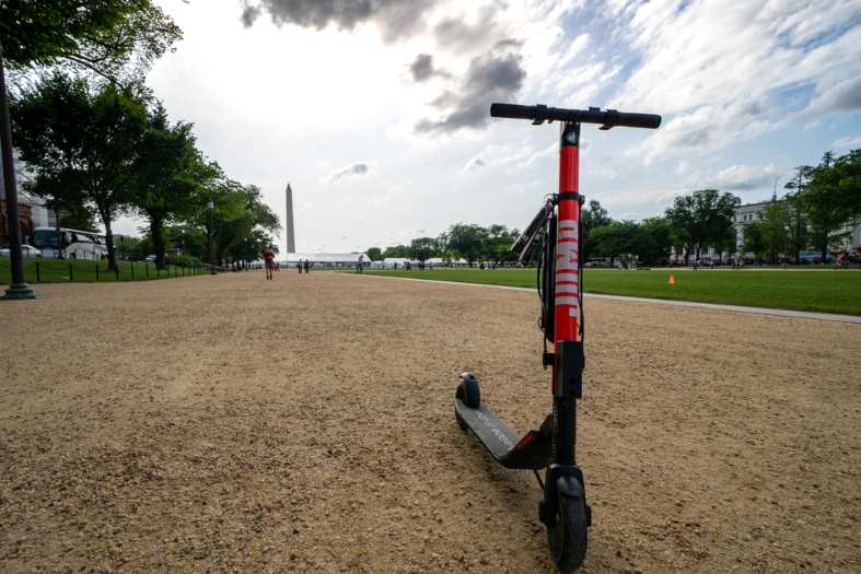 a red scooter parked near a monument in washington d.c