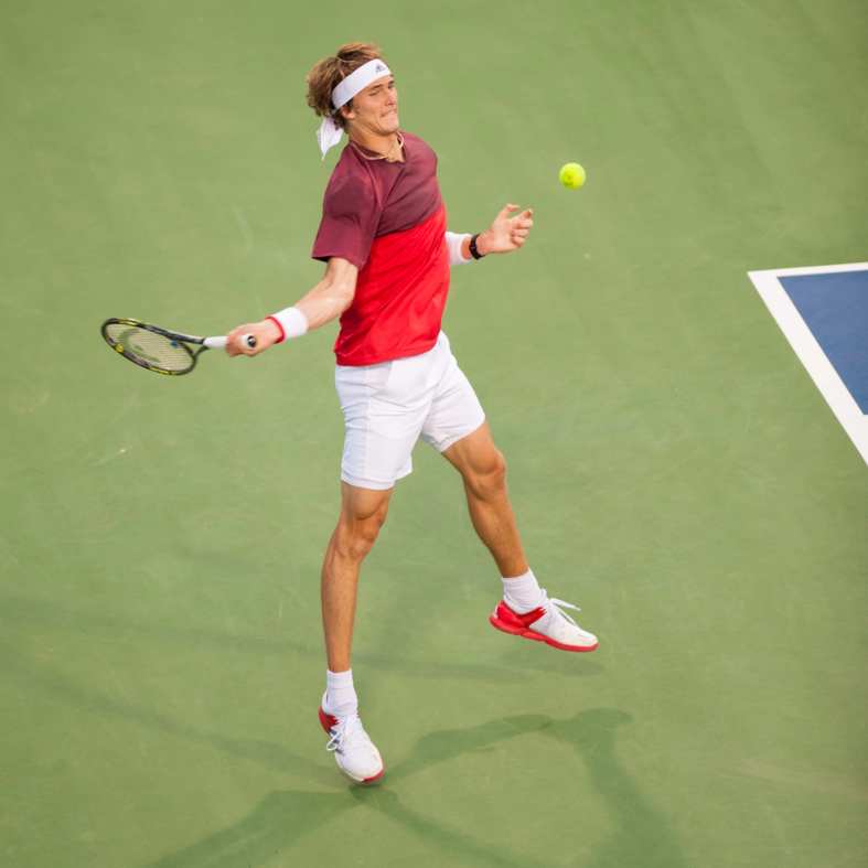a man playing tennis on a tennis court in washington d.c