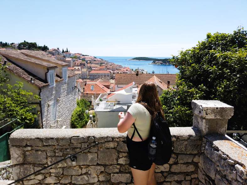 a teenage girl climbing up to Hvar castle