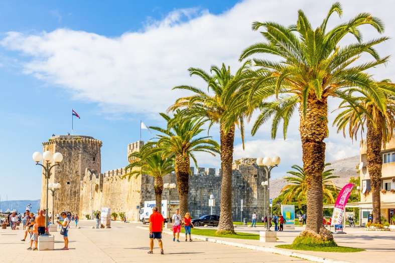 People walking towards the castle in Trogir Croatia