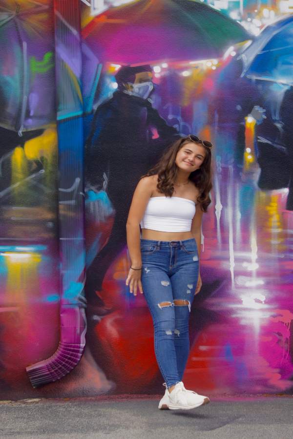 a teenage girl looking at the street art in Wynwood Miami