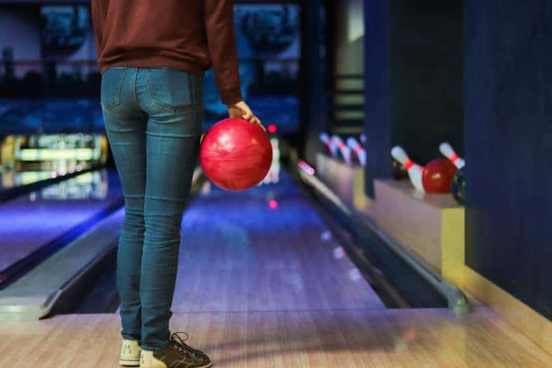 a young adult doing 10 pin bowling