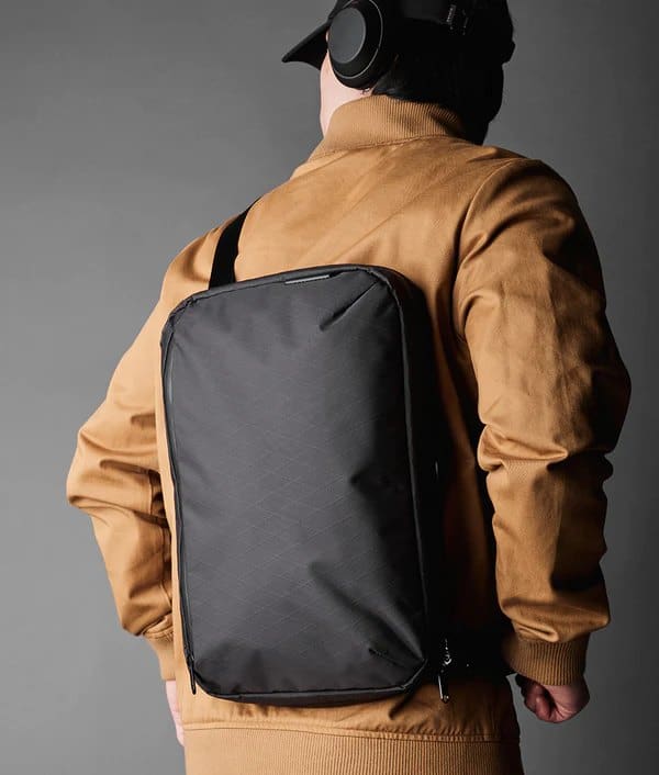 a young man wearing a gaming backpack to carry his laptop