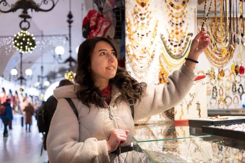 a teenage girl looking at christmas presents in Krakow