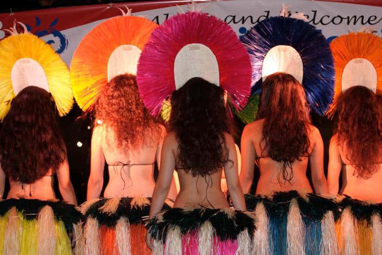 a traditional Hawaiian luau event with vibrant decorations, cultural performances, and people enjoying the festivities