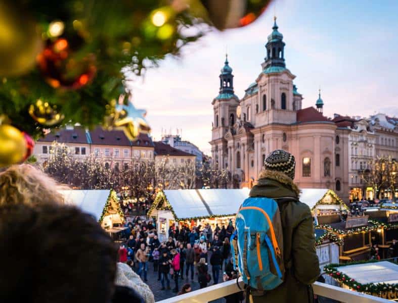 a young adult looking over the prague christmas market
