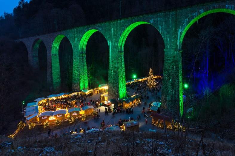 a market in the black forest under a train bridge